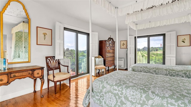 bedroom with wood finished floors and access to outside