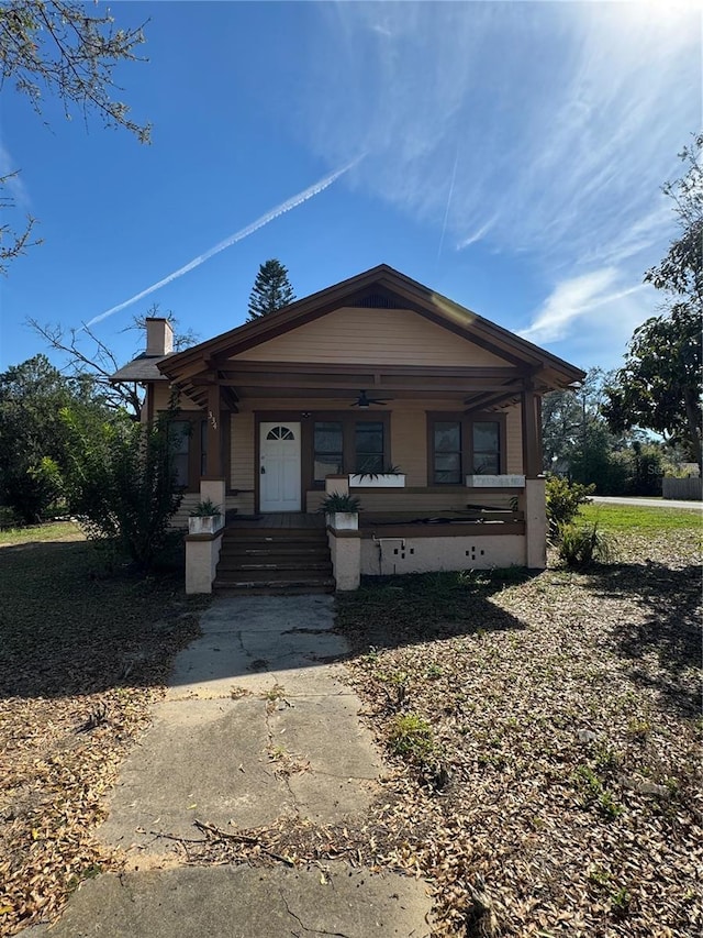 view of front of house with a porch and a chimney