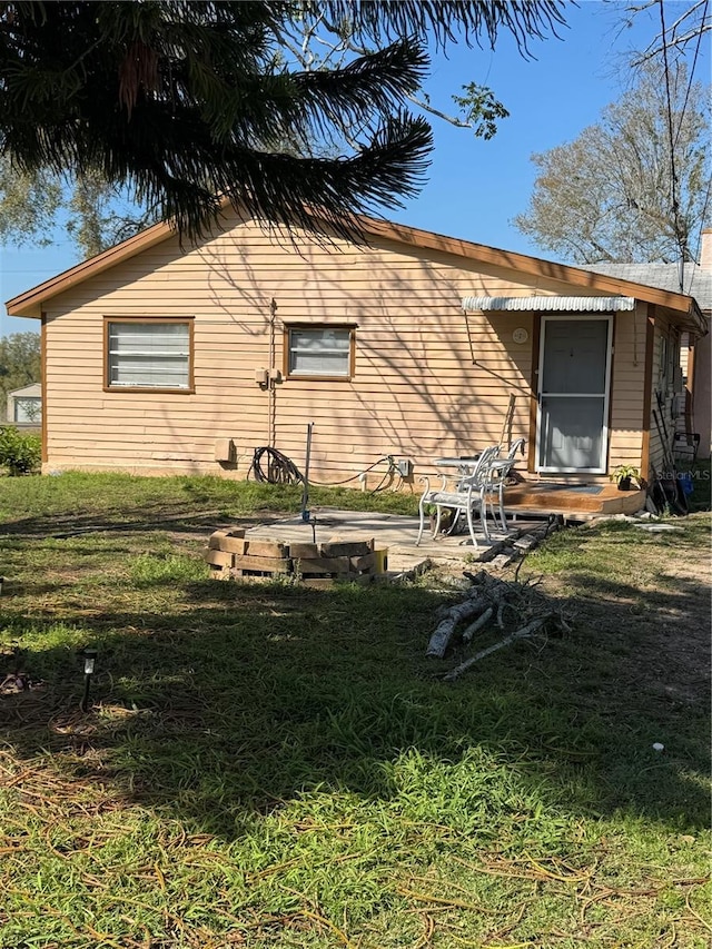 rear view of house with a patio area and a yard