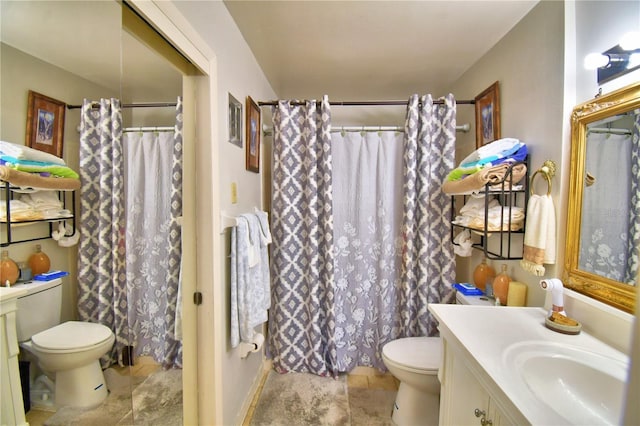 bathroom with curtained shower, toilet, vanity, and stone finish flooring