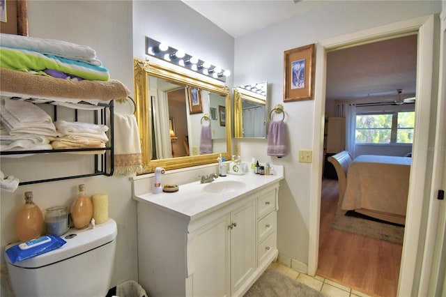 ensuite bathroom featuring vanity, toilet, tile patterned flooring, and ensuite bathroom