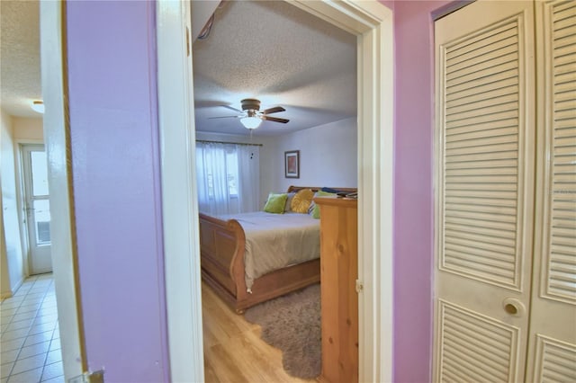 bedroom featuring light tile patterned flooring and a textured ceiling