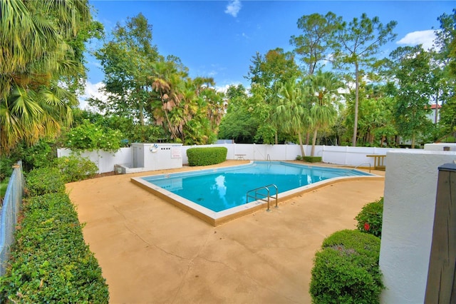 pool with a patio area and a fenced backyard