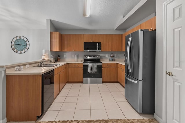 kitchen featuring light countertops, light tile patterned floors, a peninsula, stainless steel appliances, and a sink