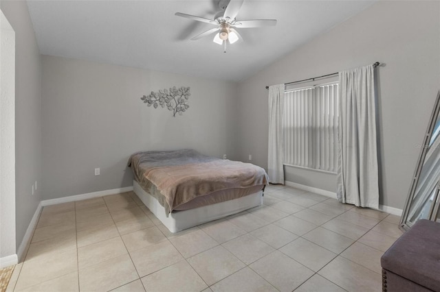 bedroom with light tile patterned floors, a ceiling fan, baseboards, and vaulted ceiling