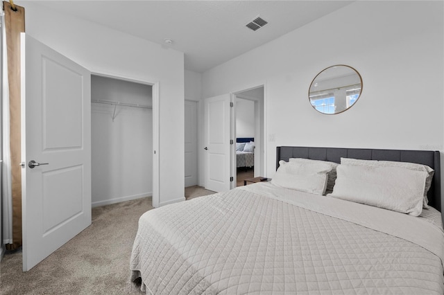 bedroom with a closet, visible vents, and carpet floors