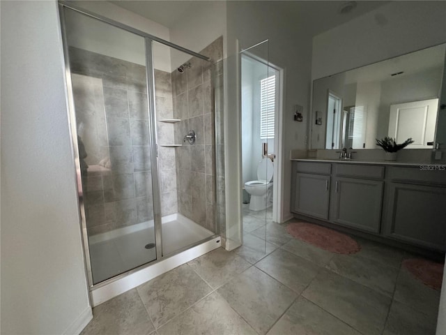 full bathroom with toilet, a stall shower, and vanity