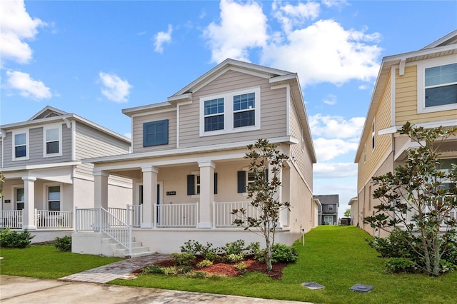 view of front of house with a porch and a front yard