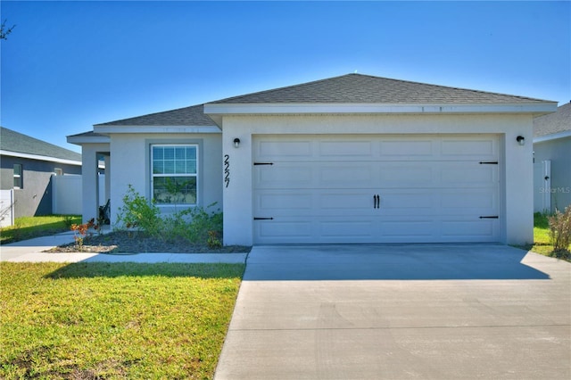 single story home with stucco siding, a front lawn, driveway, an attached garage, and a shingled roof