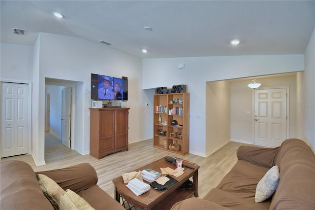 living room featuring light wood finished floors, visible vents, and recessed lighting