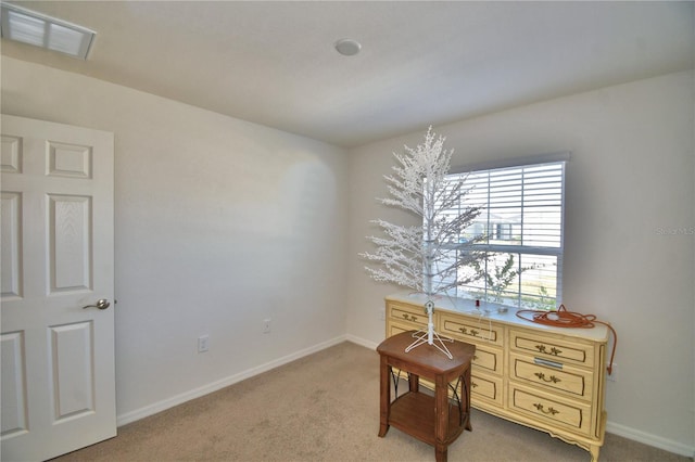 office space featuring visible vents, baseboards, and light colored carpet