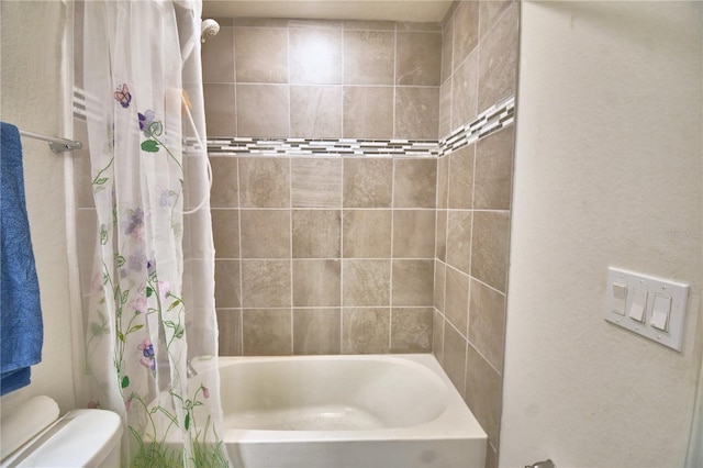 bathroom with toilet and shower / bath combo