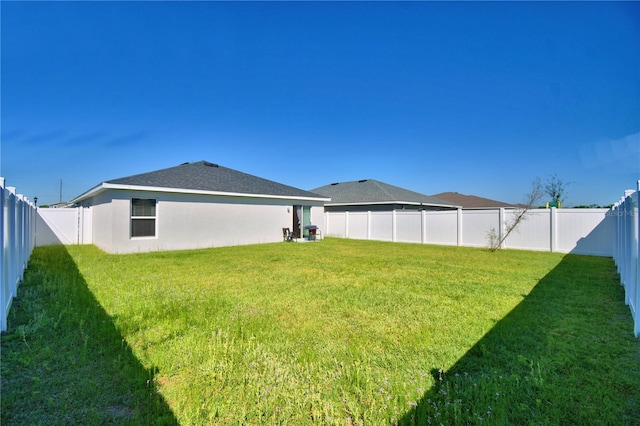 view of yard with a fenced backyard