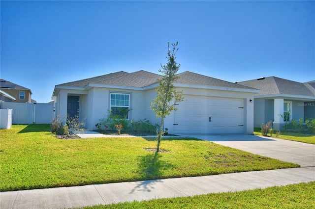 ranch-style house with concrete driveway, an attached garage, a front yard, and stucco siding