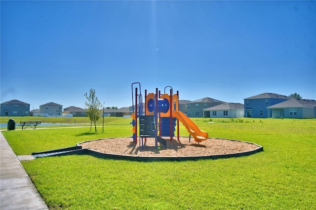 community jungle gym with a lawn and a residential view