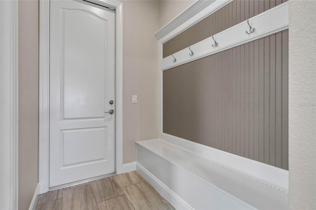 mudroom with light wood-style floors and baseboards