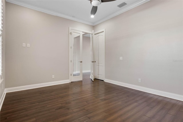 unfurnished bedroom featuring dark wood-style floors, visible vents, crown molding, and baseboards