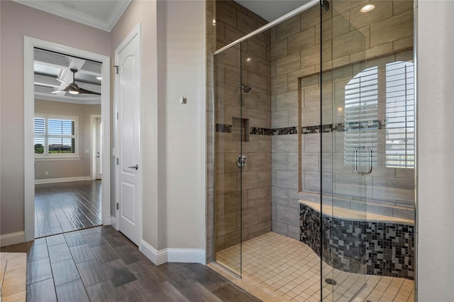 full bath featuring baseboards, wood tiled floor, a shower stall, and crown molding