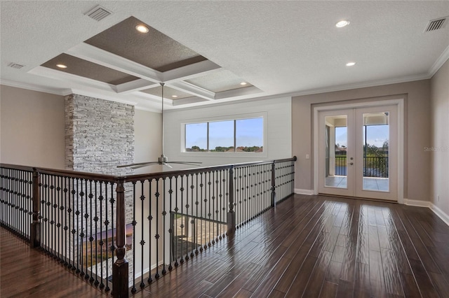 interior space with visible vents, ornamental molding, french doors, wood finished floors, and a textured ceiling