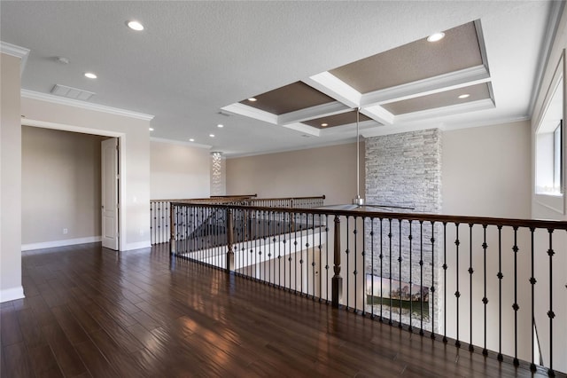 empty room with visible vents, crown molding, baseboards, wood finished floors, and a textured ceiling