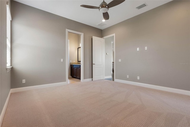 interior space featuring visible vents, baseboards, and light colored carpet