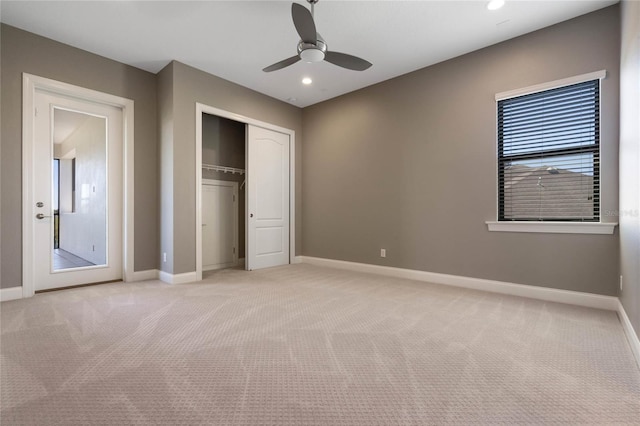 unfurnished bedroom featuring baseboards, recessed lighting, ceiling fan, a closet, and light carpet