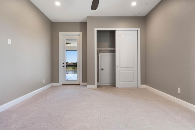 unfurnished bedroom with access to exterior, baseboards, light colored carpet, recessed lighting, and a closet