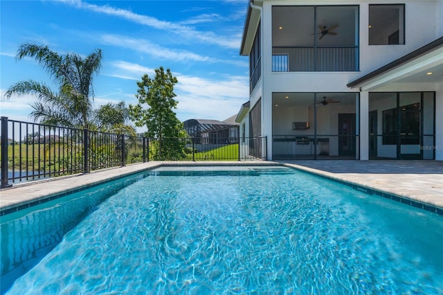 view of swimming pool with a fenced in pool, a patio area, ceiling fan, and fence