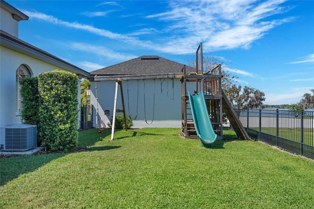 view of yard with a playground, central AC, and fence