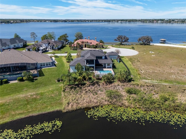 drone / aerial view featuring a residential view and a water view