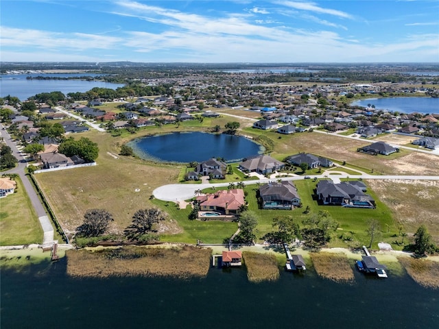 drone / aerial view with a residential view and a water view