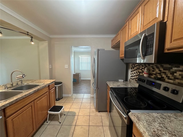 kitchen featuring a sink, stainless steel appliances, ornamental molding, and brown cabinetry