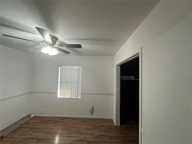 spare room featuring wood finished floors and a ceiling fan