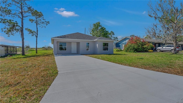 view of front of property with stucco siding and a front lawn