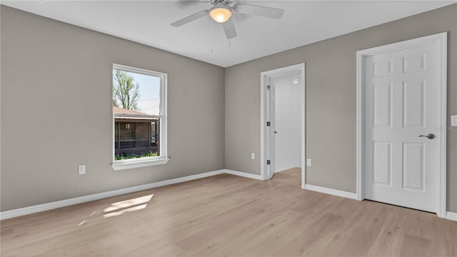 unfurnished bedroom with light wood-style flooring, baseboards, and ceiling fan