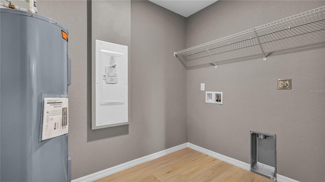 laundry room with hookup for a washing machine, hookup for an electric dryer, laundry area, light wood-style flooring, and water heater