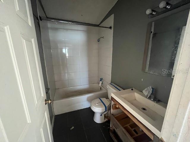 bathroom featuring tile patterned floors, vanity, toilet, and bathing tub / shower combination