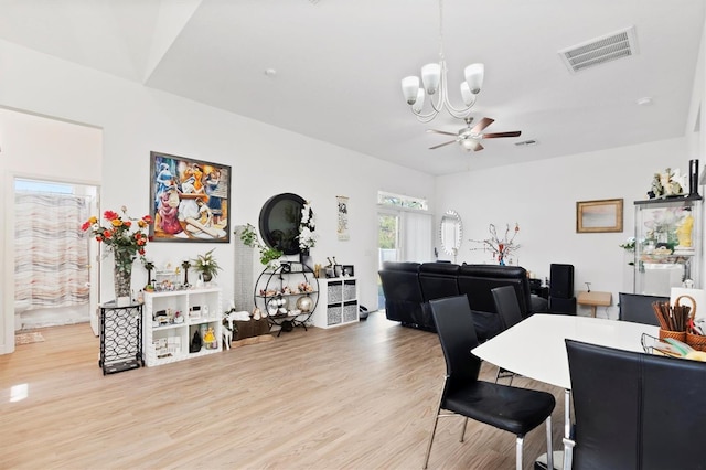 747 Fraser Ct, Kissimmee, FL 34759 - dining room featuring visible vents, light wood finished floors, and ceiling fan with notable chandelier