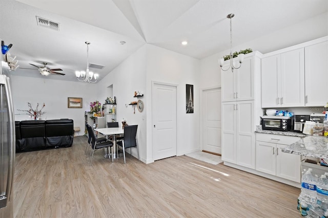 747 Fraser Ct, Kissimmee, FL 34759 - kitchen featuring white cabinets, visible vents, and light wood finished floors