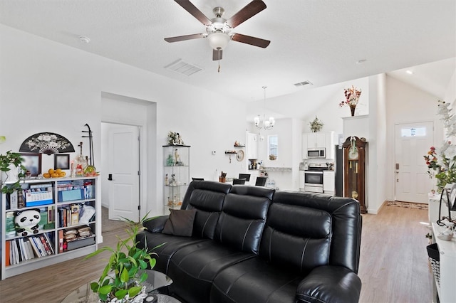 747 Fraser Ct, Kissimmee, FL 34759 - living area with light wood-style floors, vaulted ceiling, visible vents, and ceiling fan with notable chandelier
