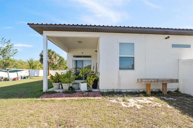 747 Fraser Ct, Kissimmee, FL 34759 - rear view of property with a lawn, fence, and metal roof