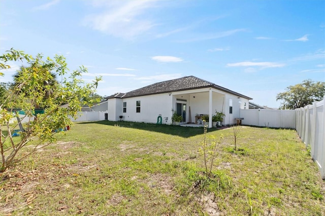 747 Fraser Ct, Kissimmee, FL 34759 - exterior space with a fenced backyard, a yard, and stucco siding
