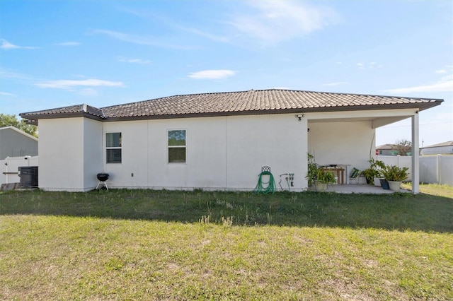 747 Fraser Ct, Kissimmee, FL 34759 - view of side of home featuring fence, a tiled roof, central air condition unit, a patio, and a lawn