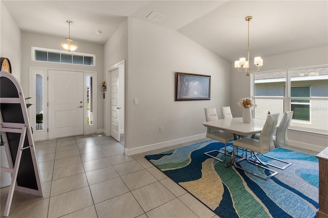 dining room with visible vents, baseboards, a chandelier, vaulted ceiling, and light tile patterned floors