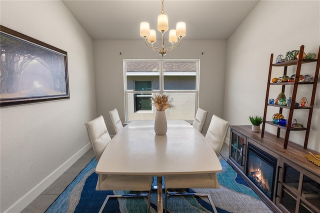 dining area with baseboards and an inviting chandelier