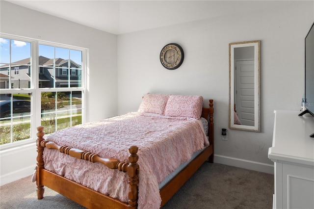 carpeted bedroom featuring baseboards