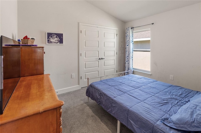 bedroom featuring a closet, baseboards, carpet, and vaulted ceiling