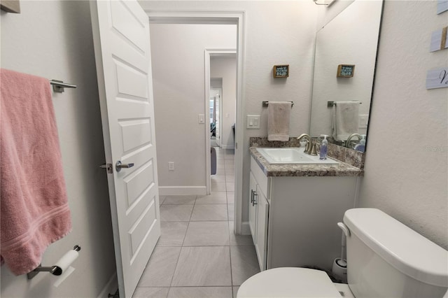 bathroom with vanity, tile patterned floors, and toilet