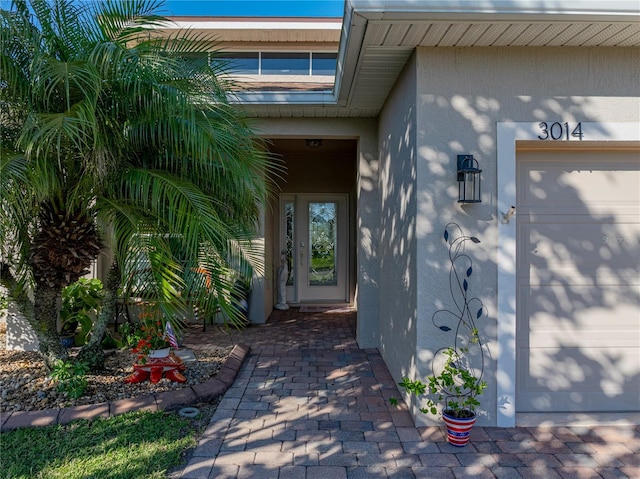 view of exterior entry featuring stucco siding