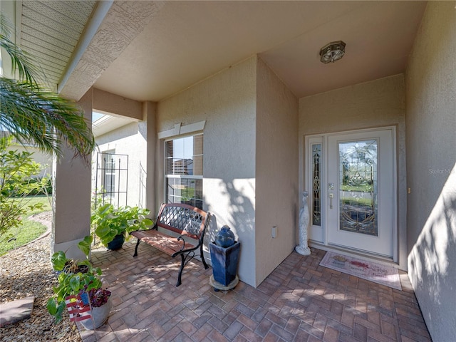 property entrance featuring stucco siding